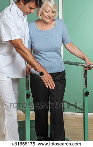 Stock Photography - women rehabilitating her legs with his doctor. Fotosearch