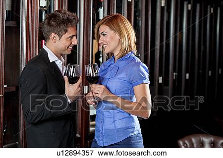 Young couple in love making a toast View Large Photo Image Stock Photo - Young couple in love making a toast. Fotosearch