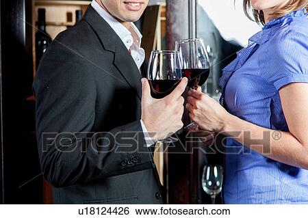 Young couple in love making a toast View Large Photo Image Stock Photograph - Young couple in love making a toast. Fotosearch
