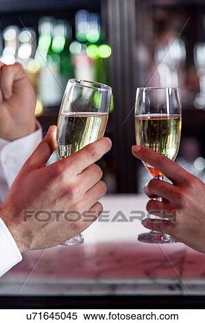 Stock Photography - Young couple in love making a toast. Fotosearch