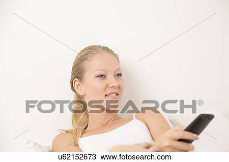 Young woman watching tv View Large Photo Image Stock Image - Young woman watching tv. Fotosearch