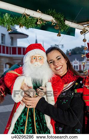 Young woman with a toy of santa View Large Photo Image Stock Photograph - Young woman with a toy of santa. Fotosearch