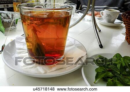 Stock Photo - A cup of tea - hot water with a tea bag. Fotosearch