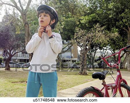 Boy of seven rides his bicycle in an urban park View Large Photo Image Stock Photo - Boy of seven rides his bicycle in an urban park. Fotosearch