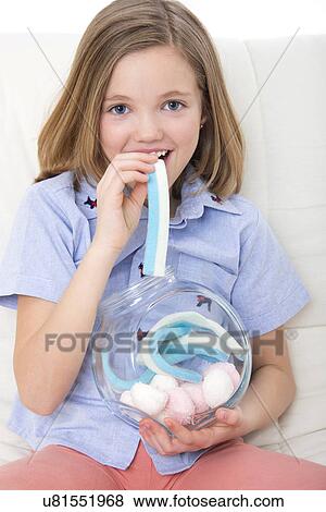 Stock Photo - Girl eating candy.. Fotosearch