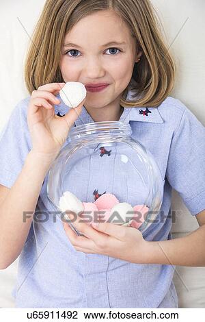 Girl holding marshmallows. View Large Photo Image Stock Image - Girl holding marshmallows.. Fotosearch