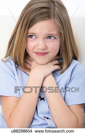 Picture - Girl touching her throat.. Fotosearch