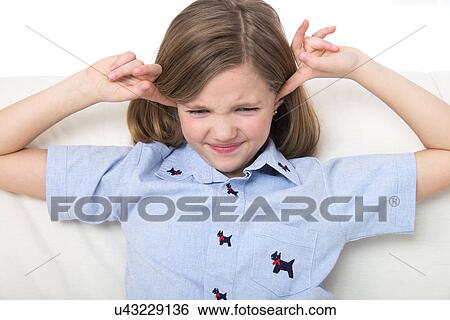Girl with her fingers in her ears. View Large Photo Image Stock Photograph - Girl with her fingers in her ears.. Fotosearch