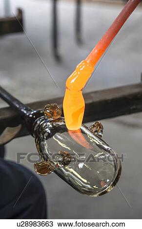 Glassblower cuts molten glass with a hand tool View Large Photo Image Stock Image - Glassblower cuts molten glass with a hand tool. Fotosearch