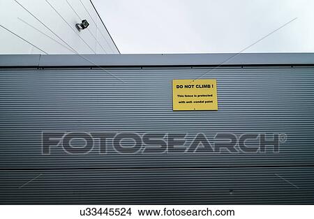 "Metal clad industrial building with sign warning of anti-vandal paint. Anti-vandal paint uses a non-drying oil so that it remains permanently greasy and slippery, and leaves marks on intruders. " View Large Illustration Stock Illustration - "Metal clad industrial building with sign warning of anti-vandal paint. Anti-vandal paint uses a non-drying oil so that it remains permanently greasy and slippery, and leaves marks on intruders. ". Fotosearch