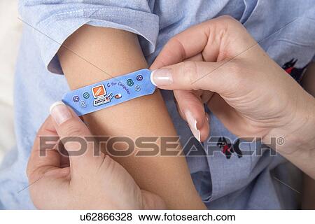 Person applying plaster to girl's arm. View Large Photo Image Stock Photo - Person applying plaster to girl's arm.. Fotosearch