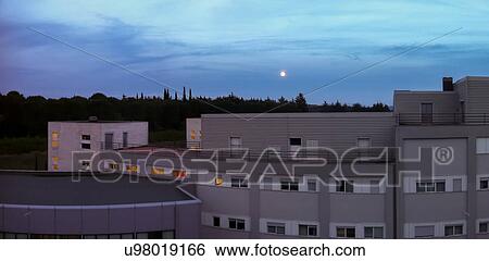 Stock Photograph - Full moom rising over Hospital Silvestrini, Perugia, Umbria, Italy. Fotosearch