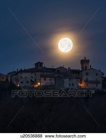 Stock Photo - Moon setting over MonteCastello di Vibio. Fotosearch