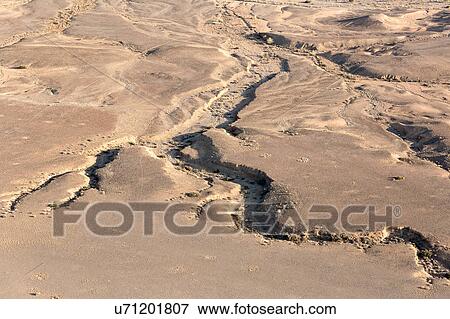 Stock Photo - River carvings in the sand. Fotosearch