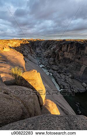 Stock Image - Rocky river gorge at first light. Fotosearch