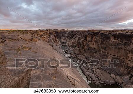 Stock Photo - Rocky river gorge at first light. Fotosearch