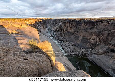Stock Photography - Rocky river gorge at first light. Fotosearch