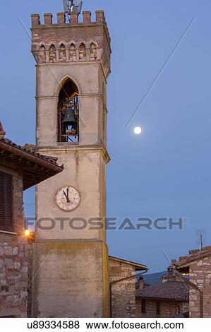 Umbrian medieval street of MonteCastello di Vibio, Italy at sun rise with full moon setting over campanile View Large Photo Image Stock Photo - Umbrian medieval street of MonteCastello di Vibio, Italy at sun rise with full moon setting over campanile. Fotosearch