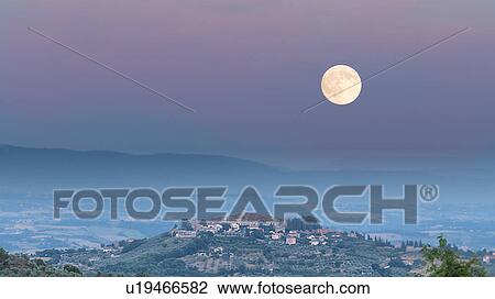 Umbrian medieval town of MonteCastello di Vibio, Italy at sunset with full moon rising View Large Photo Image Stock Image - Umbrian medieval town of MonteCastello di Vibio, Italy at sunset with full moon rising. Fotosearch