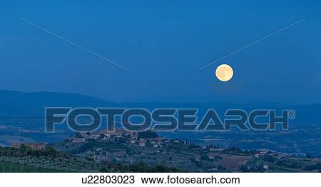 Umbrian medieval town of MonteCastello di Vibio, Italy at sunset with full moon rising View Large Photo Image Stock Image - Umbrian medieval town of MonteCastello di Vibio, Italy at sunset with full moon rising. Fotosearch