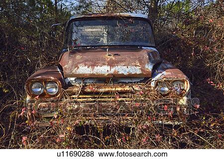 Stock Photo - Abandoned rusty car in field. Fotosearch