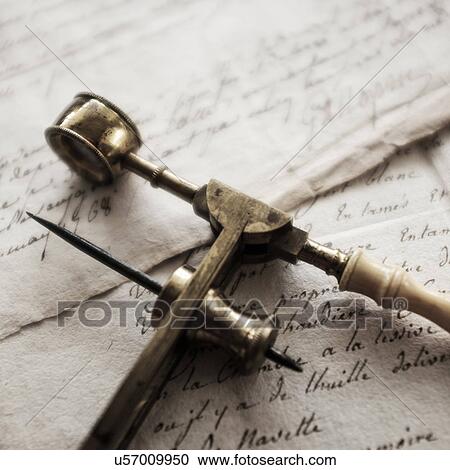 Stock Image - Antique microscope and letters. Fotosearch