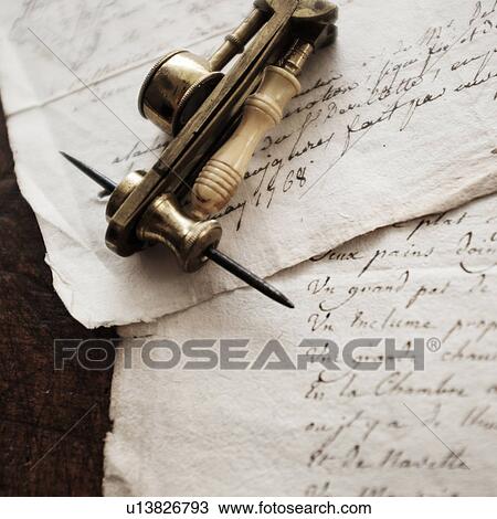 Stock Image - Antque microscope and letters. Fotosearch