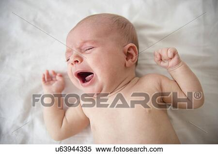 Stock Photography - Baby girl (2-5 months) crying in crib. Fotosearch