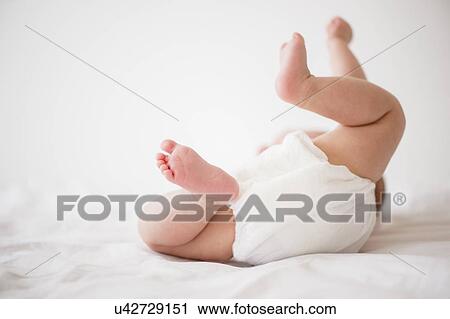 Baby girl (2-5 months) lying on bed View Large Photo Image Stock Image - Baby girl (2-5 months) lying on bed. Fotosearch