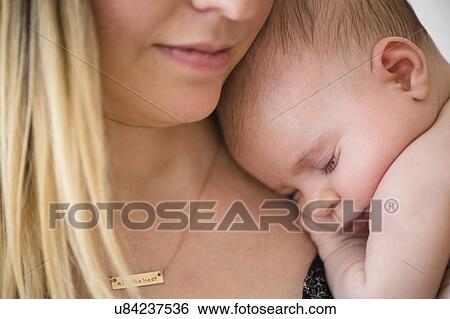 Baby girl (2-5 months) sleeping on mother's shoulder View Large Photo Image Stock Photograph - Baby girl (2-5 months) sleeping on mother's shoulder. Fotosearch