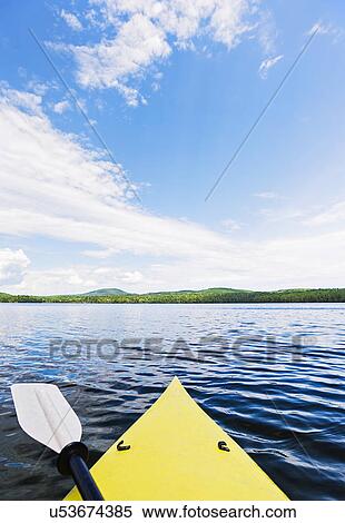 Bow of yellow kayak on lake View Large Photo Image Stock Photography - Bow of yellow kayak on lake. Fotosearch