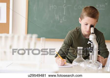 Boy (8-9) looking through microscope View Large Photo Image Stock Image - Boy (8-9) looking through microscope. Fotosearch