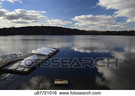 Stock Photograph - Cloud reflection over boat dock Jamaica Pond. Fotosearch