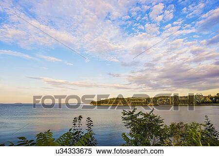 Stock Photography - Cloudy sky above bay. Fotosearch