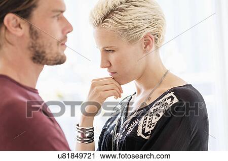 Stock Image - Couple arguing in living room. Fotosearch