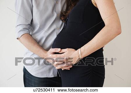 Stock Image - Couple holding hands. Fotosearch