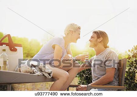 Couple laughing on rooftop View Large Photo Image Stock Image - Couple laughing on rooftop. Fotosearch