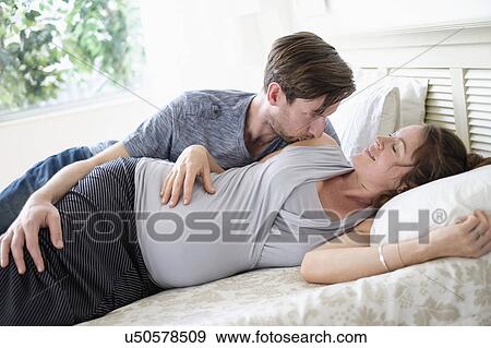 Stock Photo - Couple lying in bed. Fotosearch
