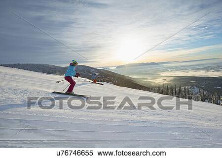 Couple skiing at sunset View Large Photo Image Stock Photography - Couple skiing at sunset. Fotosearch