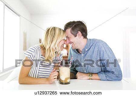 Couple spending time at home and drinking beer View Large Photo Image Stock Photography - Couple spending time at home and drinking beer. Fotosearch