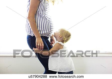 Daughter (2-3) with pregnant mother View Large Photo Image Stock Photo - Daughter (2-3) with pregnant mother. Fotosearch
