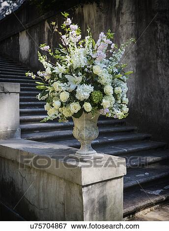 Display of flowers in stone urn View Large Photo Image Stock Photo - Display of flowers in stone urn. Fotosearch