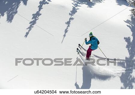 Elevated view of woman skiing View Large Photo Image Picture - Elevated view of woman skiing . Fotosearch