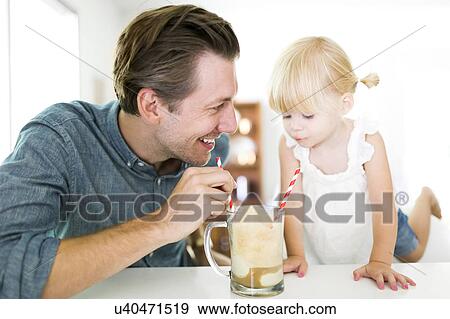 Father drinking milkshake with daughter (2-3) View Large Photo Image Stock Photo - Father drinking milkshake with daughter (2-3). Fotosearch