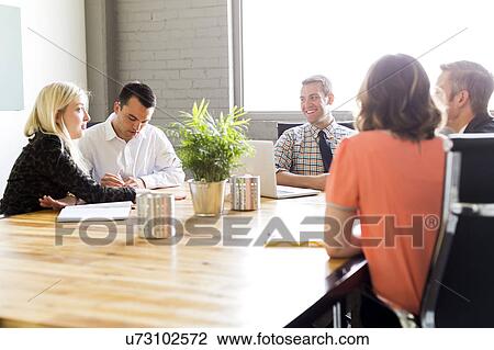 Five office workers during meeting View Large Photo Image Stock Image - Five office workers during meeting. Fotosearch
