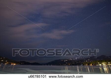 Stock Image - Frozen Whitefish Lake at night. Fotosearch