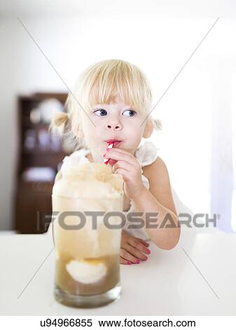 Stock Photography - Girl (2-3) drinking milkshake. Fotosearch