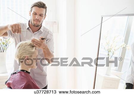 Hairdresser cutting woman's hair View Large Photo Image Stock Image - Hairdresser cutting woman's hair. Fotosearch