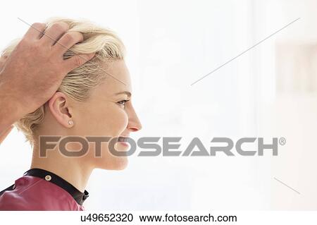 Hairdresser styling woman's hair View Large Photo Image Stock Image - Hairdresser styling woman's hair. Fotosearch