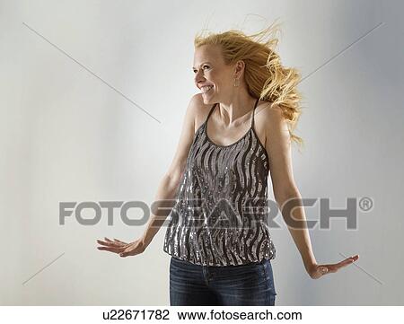 Happy woman dancing in studio View Large Photo Image Stock Image - Happy woman dancing in studio. Fotosearch